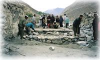 men building in Shimshal, Pakistan